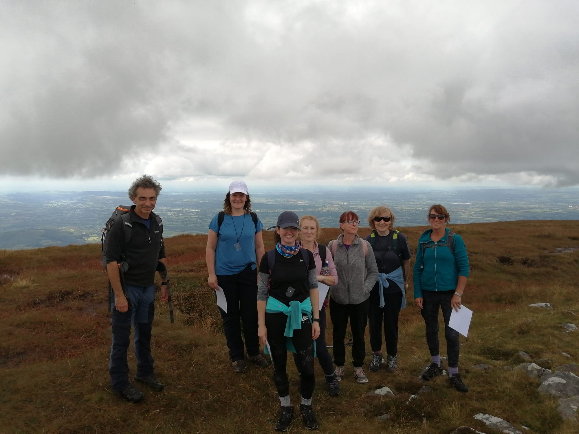 Hikers on top of a scenic Irish mountain smiling