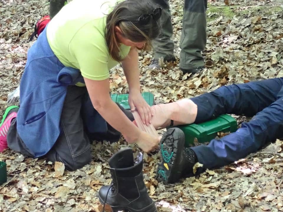Hiker preforming emergency first AID REC 3